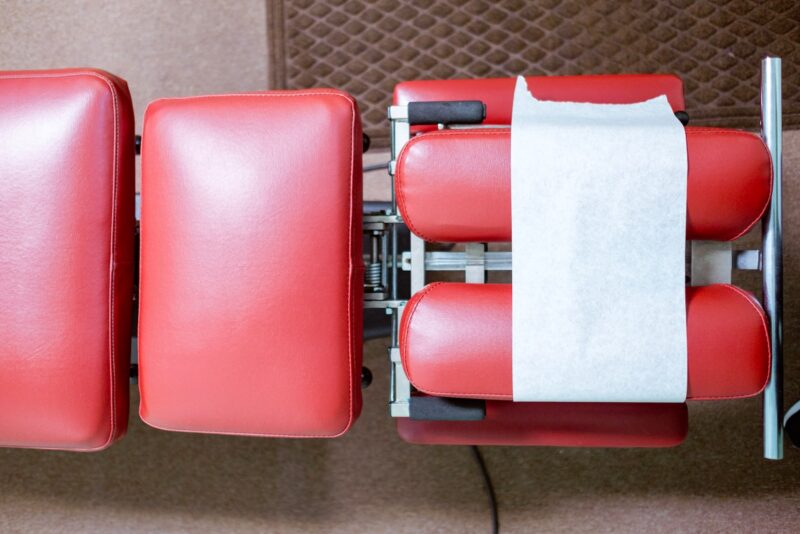 a row of red chairs with a white stripe on them