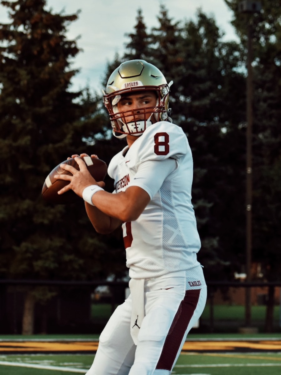 man in white and black football jersey shirt and white pants