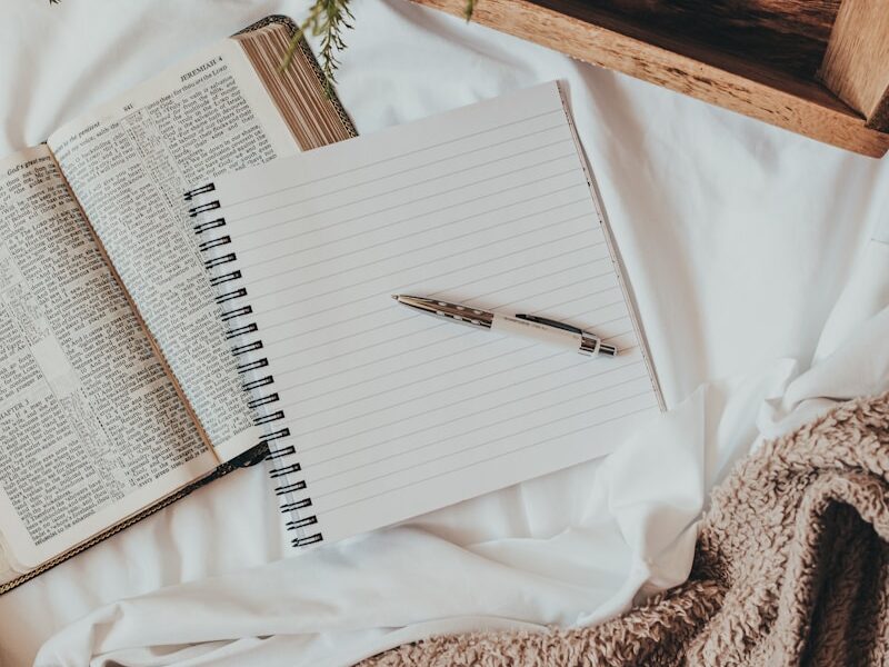 white notebook on white textile