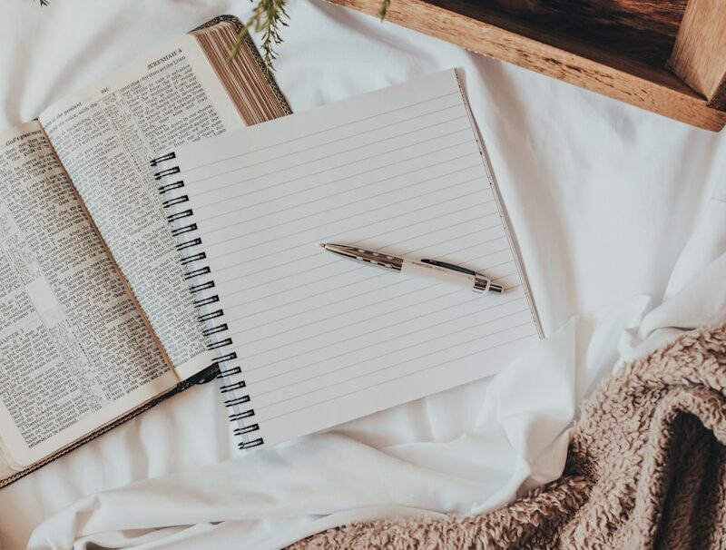 white notebook on white textile