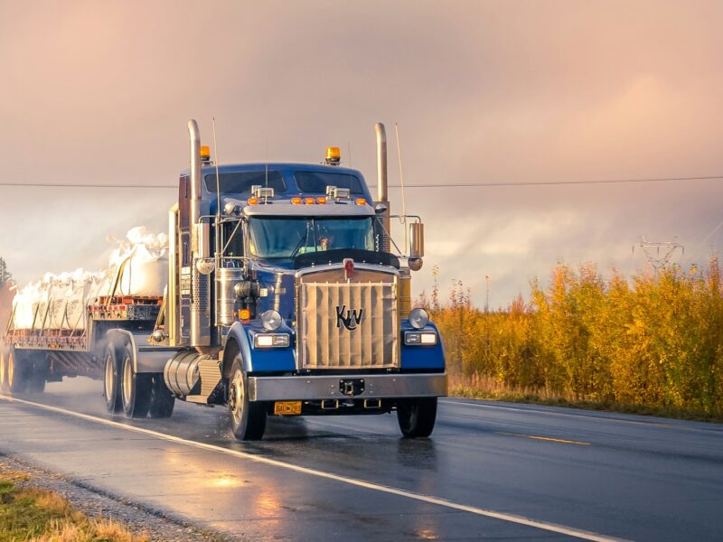 white and blue truck on road during daytime