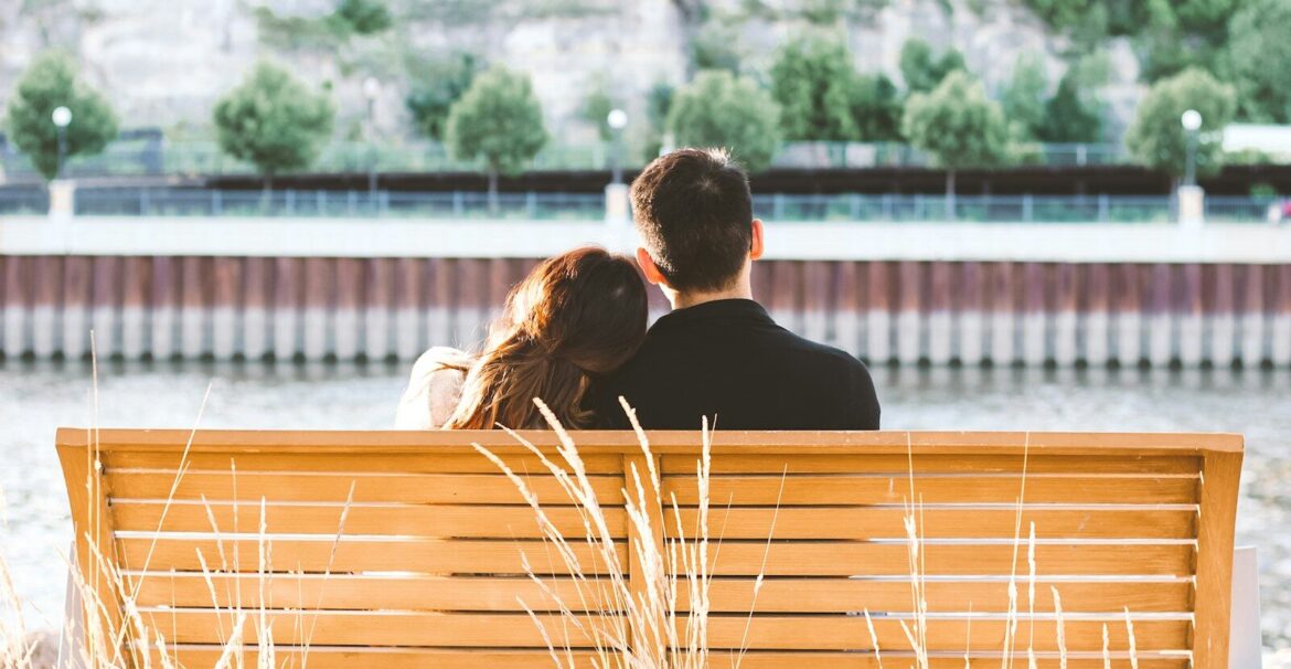 couple sitting on wooden bench