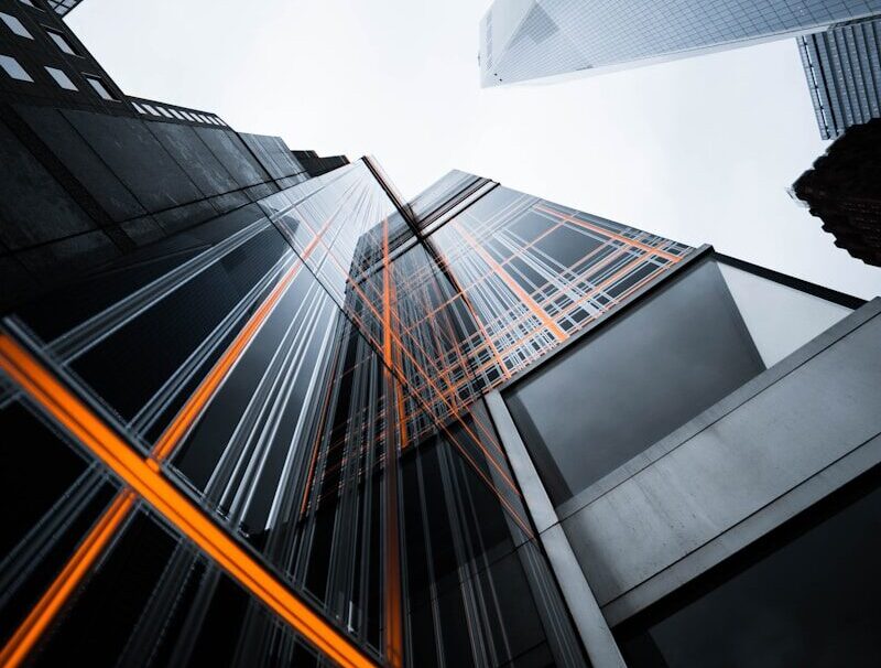 low-angle photo of high-rise buildings under white sky