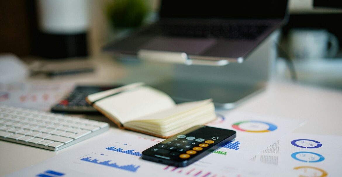 office desk with smartphone and financial charts
