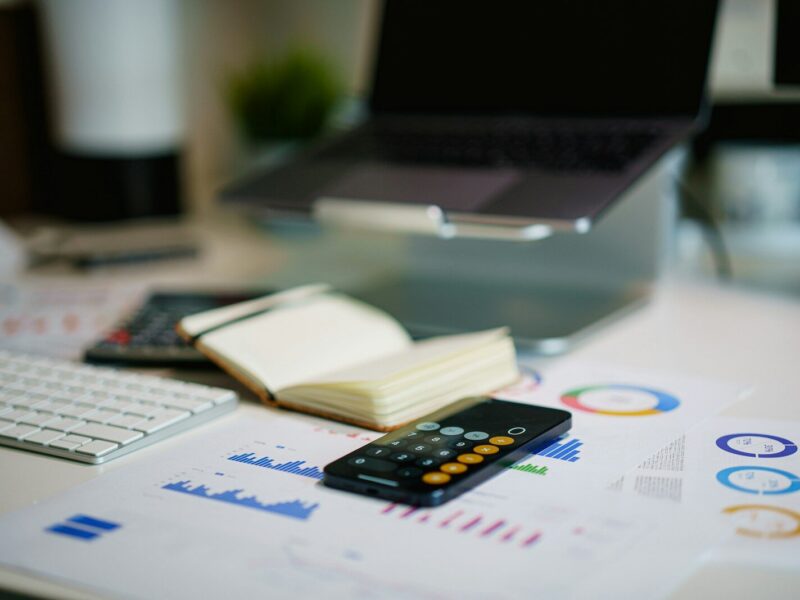 office desk with smartphone and financial charts