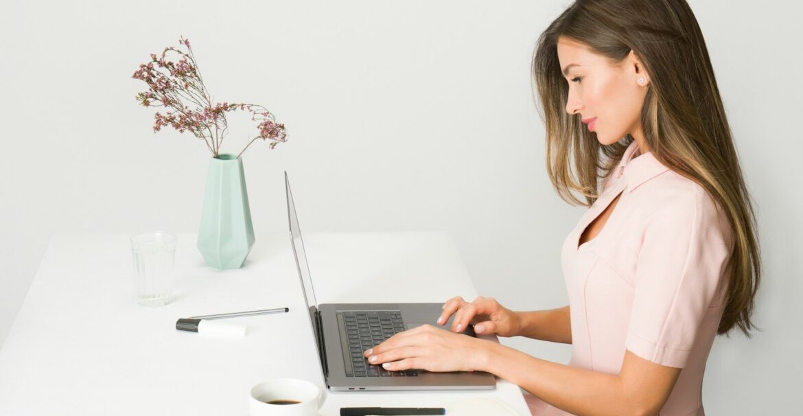 woman sitting while using laptop