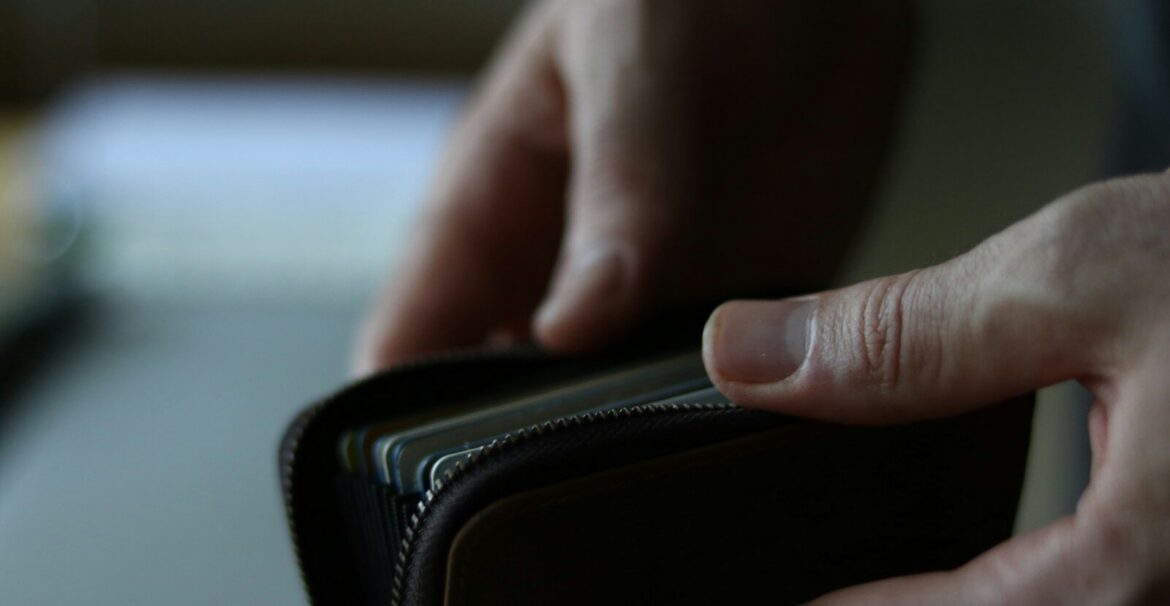 a person holding a wallet in their hand