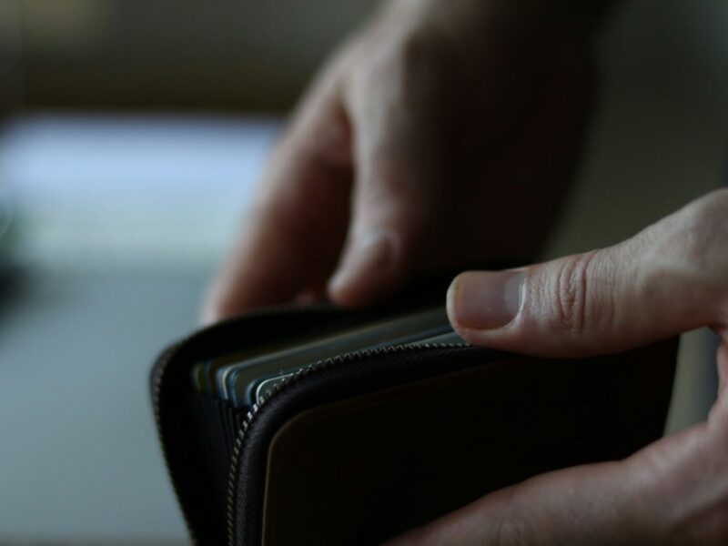 a person holding a wallet in their hand